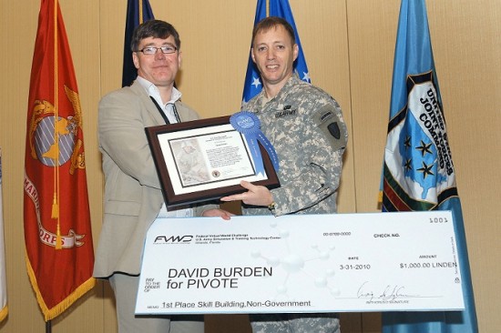 David Burden, receiving his winning prize for Daden's skills building entry of the U.S. Federal Virtual World Challenge from COL Langhauser, Director, U.S. Army Simulation & Training Technology Center. (Image courtesy Daden Limited.)