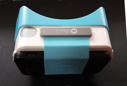 The Dscvr headset's stretchy band can fit over a variety of smartphones -- and their protective cases.