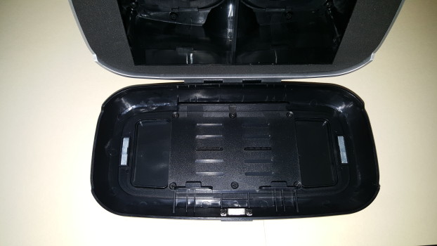 Smartphone held in place by two sliding plastic grips on springs.