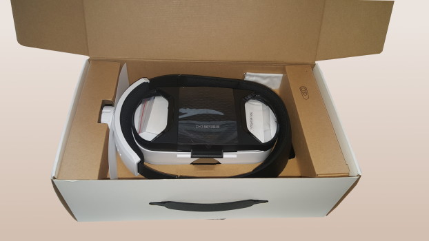 Custom-cut cardboard to protect it during shipping, with protective plastic film covering the lenses.