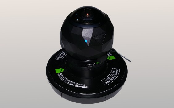 The 360fly on one of its mounts. The blue LED light indicates that the camera is on and ready.